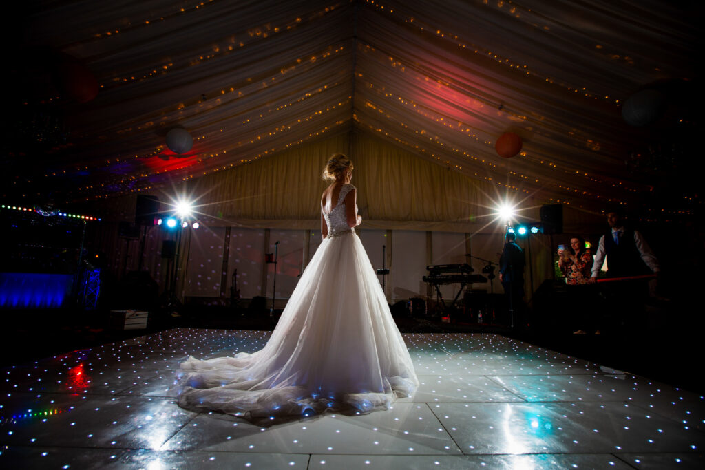Bride standing on a dance floor at the Delta hotels Forest of Arden