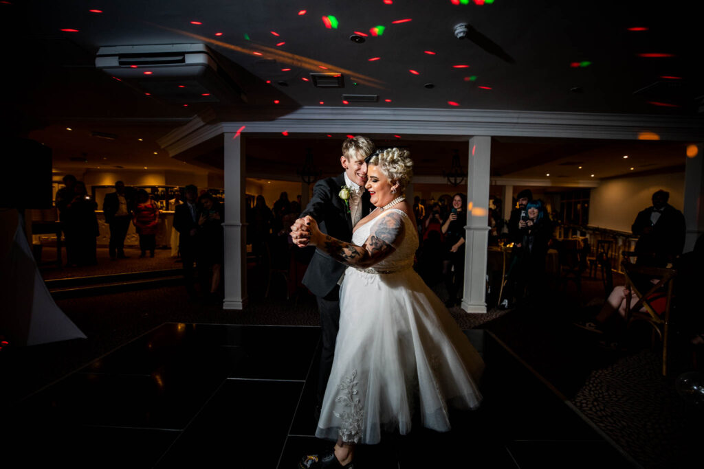 Bride and Groom dancing on their own lit up by a spotlight.