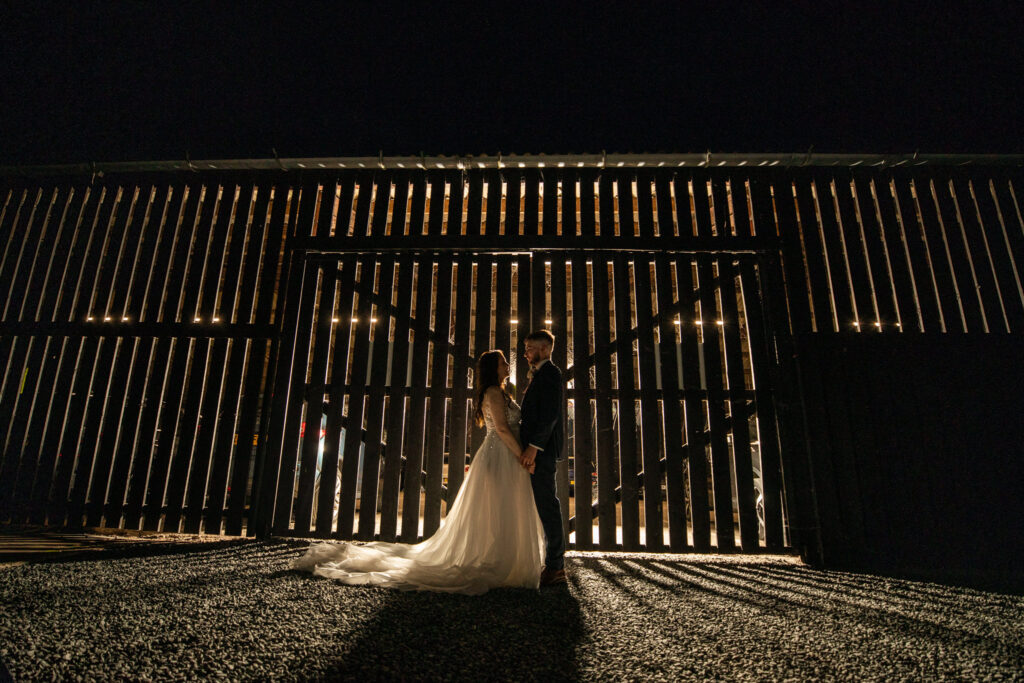 Bride and Groom standing outside the barn doors. I am a Curradine barns wedding photographer and took this shot