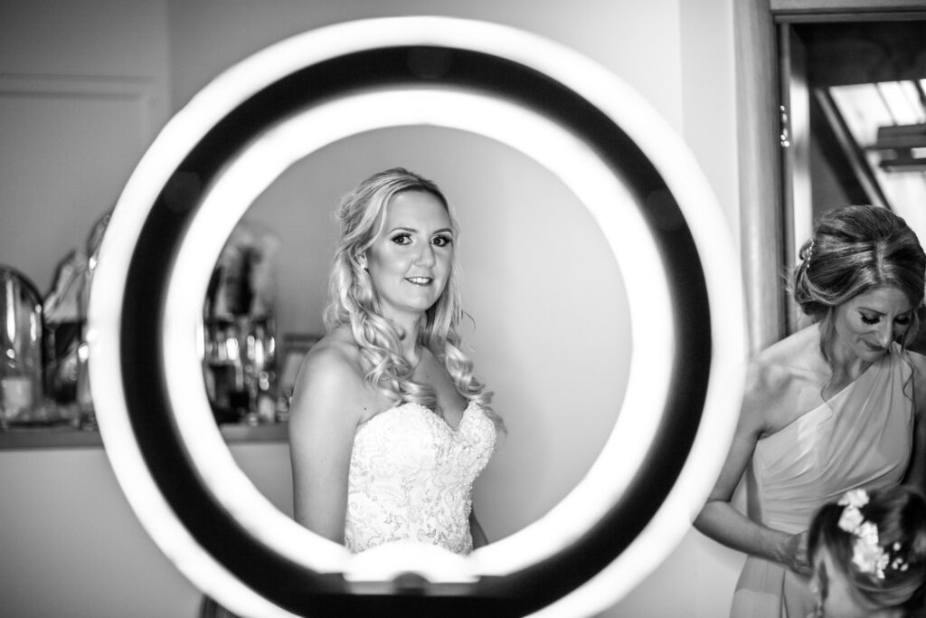 Bride looking through a mirror at Redhouse Barn in Worcestershire