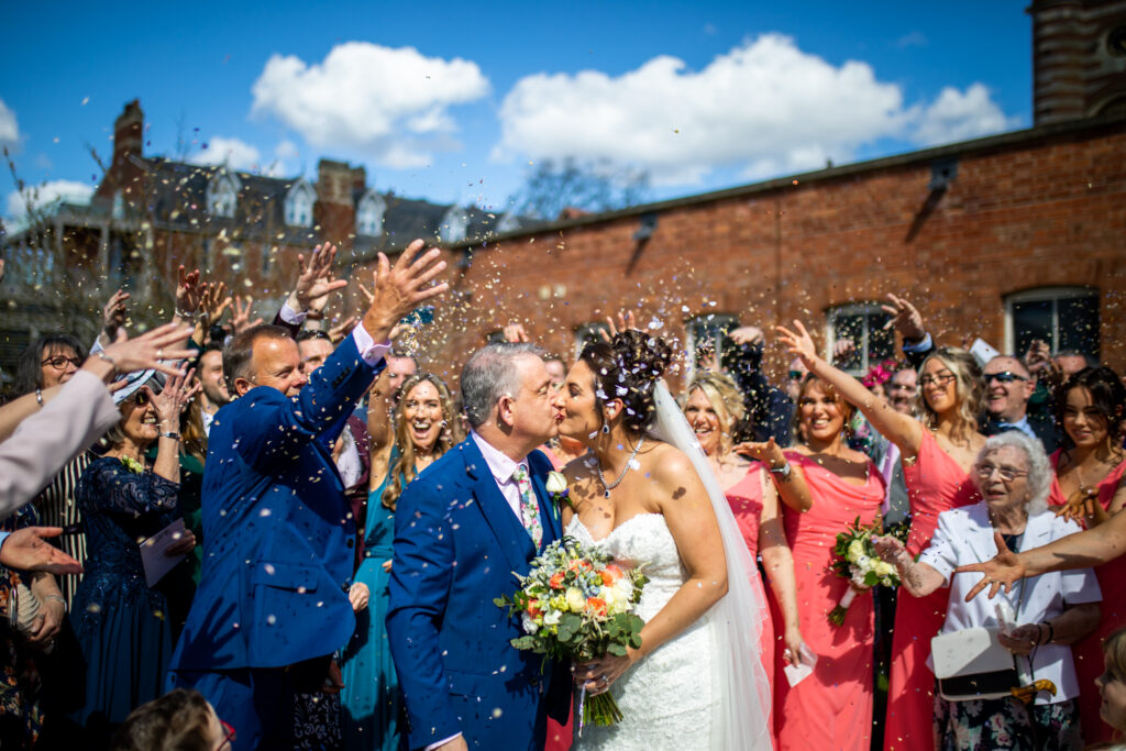 Bride and groom confetti being thrown at their Stanbrook Abbey wedding