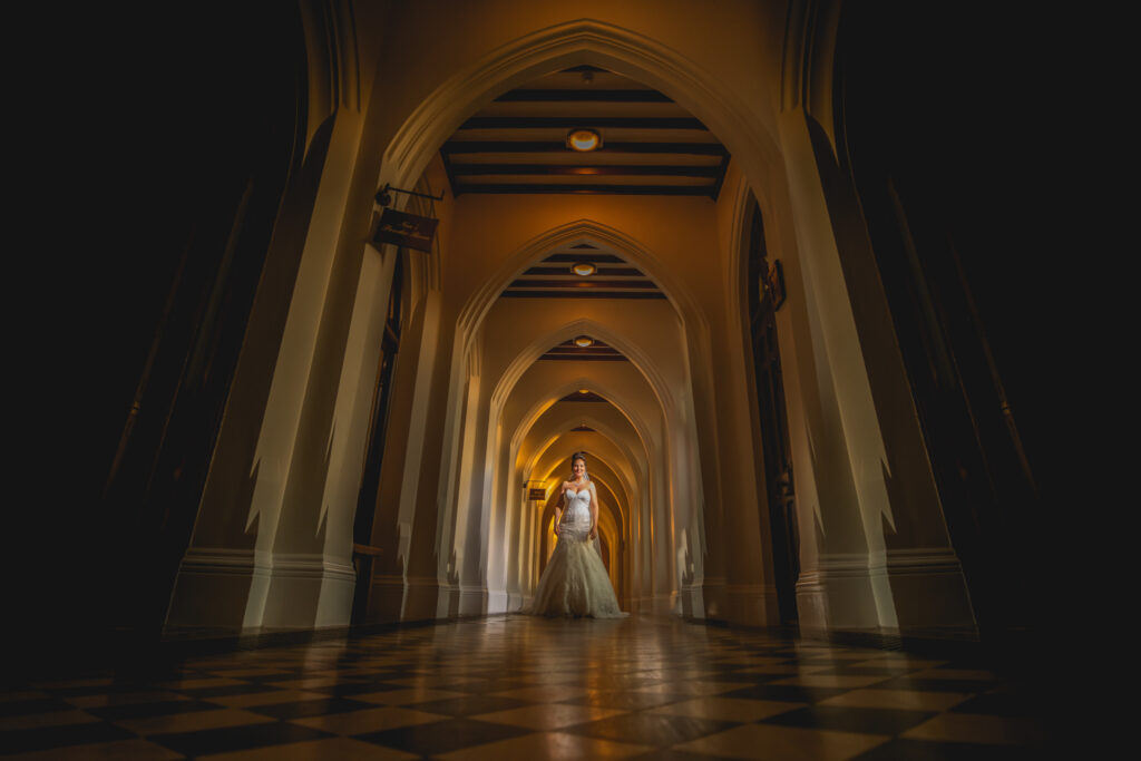 Bride walking down the hallways of Stanbrook Abbey
