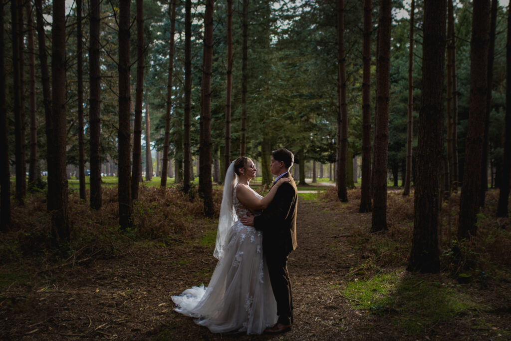 Barns Hotel Wedding Photographer photographing a couple standing in the forest at Cannock Chase