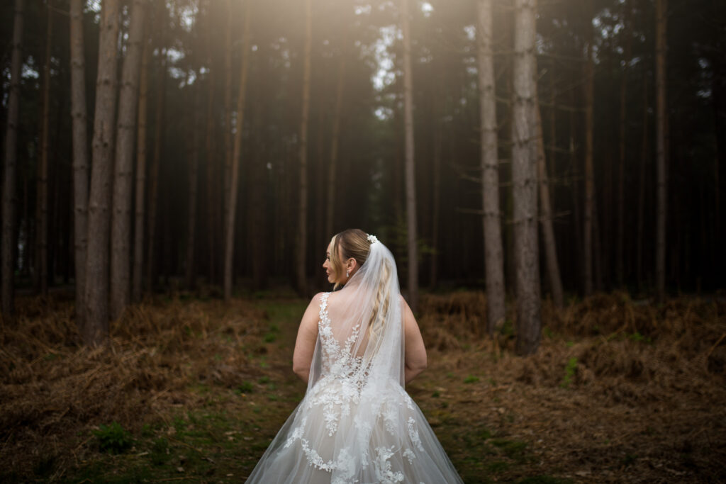 Bride standing in some trees at Cannock chase