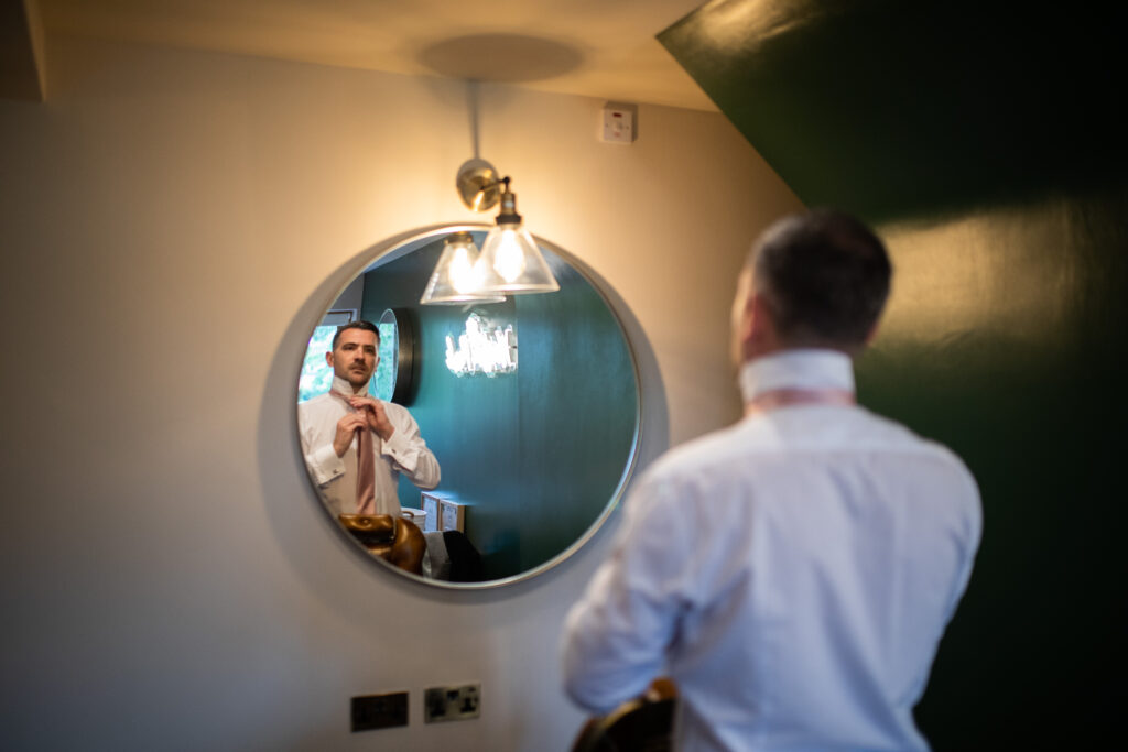 Groom getting ready in their room at Wootton Park Wedding Venue